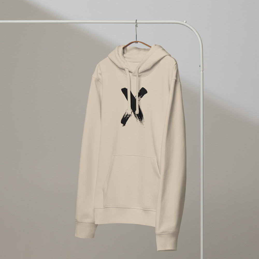 A minimal sumi-e brushstroke painting of the letter X printed on a pullover hoodie. On a hanger, Clay colourway.