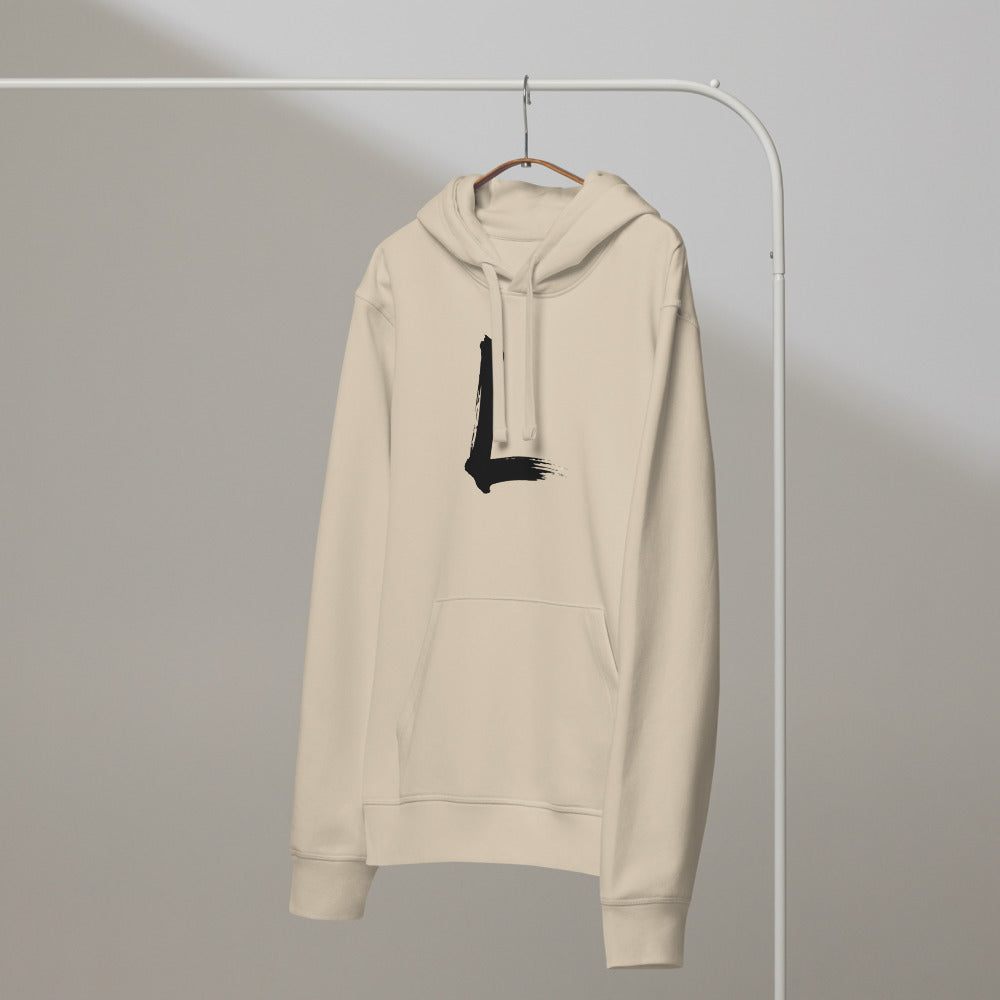 A minimalist black ink sumi-e stroke forming the letter L, printed on a classic hoodie. On a hanger, Clay colourway.