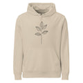 A minimal black ink illustration of a single eucalyptus stem with four ovate leaves on a unisex hoodie. Shown on the Clay (Desert Dust) colorway.