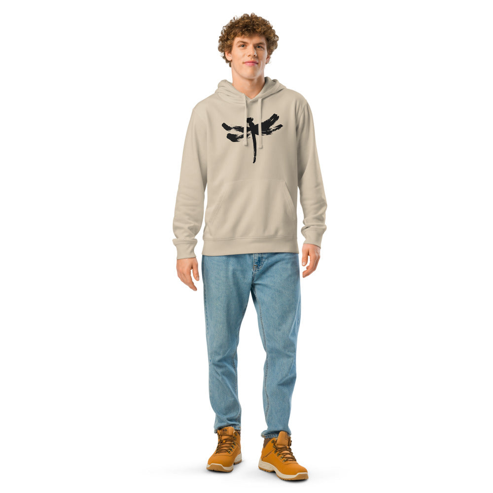A minimalist dragonfly sumi-e ink design printed on a hoodie. Worn by a man, Clay colourway.