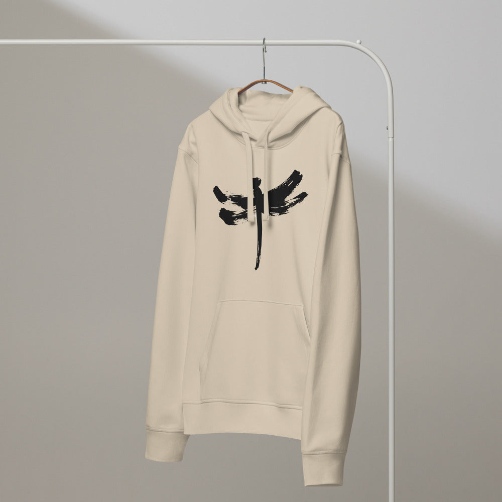 A minimalist dragonfly sumi-e ink design printed on a hoodie. On a hanger, Clay colourway.