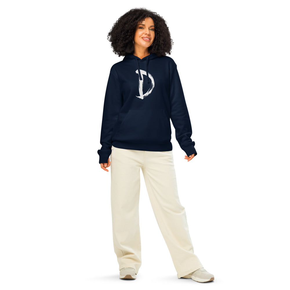 A minimalist sumi-e ink painting of the capital letter D printed on a hoodie. Worn by a woman, Ink colourway.